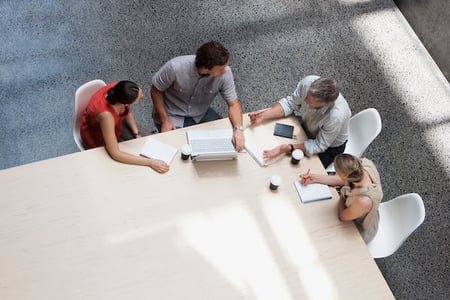 group of people sitting at a table discussing types of APIs