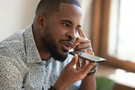 marketer talking into speaker phone on Clubhouse